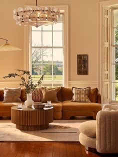 a living room filled with furniture and a chandelier