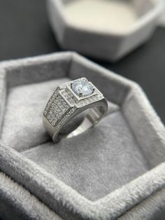 a diamond ring sits in a velvet box