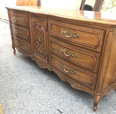 an old dresser is sitting on the ground