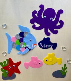 an assortment of felt sea animals on a refrigerator