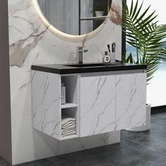 a bathroom vanity with marble counter top and round mirror above it, next to a plant