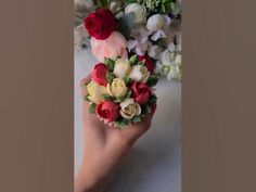 a woman's hand holding a bouquet of flowers