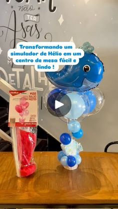 the balloon dolphin has been placed on top of a wooden table with an advertise