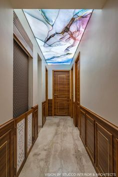 the hallway is decorated in wood and has a skylight painted on the ceiling above it