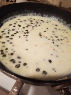 a pan filled with food sitting on top of a stove next to a burner