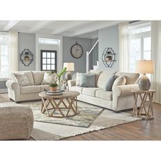 a living room with two couches, a chair and a coffee table in it