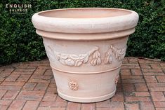 a large planter sitting on top of a brick sidewalk