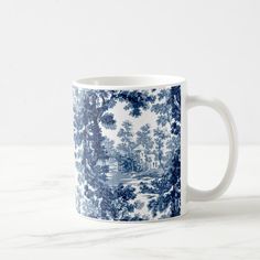 a blue and white coffee mug with trees on it