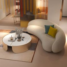 a living room with a couch, table and rugs on the floor in front of it