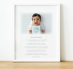 a white framed photo with a baby's name on it