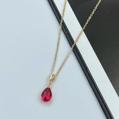 "This ruby pink crystal teardrop pendant necklace adds the finishing touch to any outfit. Perfect for yourself, your mom, best friend, bridal party, and more! The pendant frame and chain are made from anti-tarnish gold materials. Matching earrings are available in our shop for purchase. Measurements: Necklace length is 15.5\" plus 2 inches extender chain for adjustment. Teardrop crystal is 13 mm x 9 mm Necklace made in a smoke and pet free home, and comes beautifully packaged in a gift box! Clic Necklace Ruby, Pink Charm, Pink Gem, Gem Necklace, Pink Necklace, Gold Necklace Layered, Teardrop Pendant, Modern Necklaces, Crystal Charm