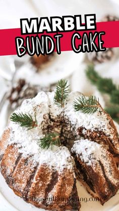 a bundt cake with powdered sugar on top and pine sprigs in the middle