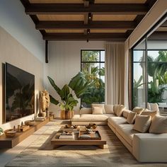 a living room filled with lots of furniture and large windows overlooking palm trees in the distance