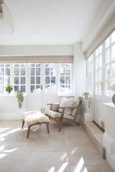 a living room filled with furniture and windows