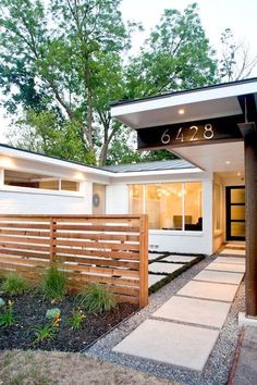 a modern house with an entry way leading to the front door