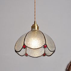 a stained glass light hanging from a ceiling