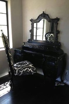 an ornate black desk and chair in a room