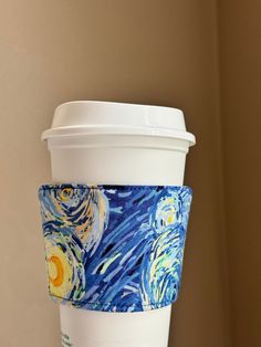 a coffee cup sleeve with an image of the starry night painting on it's side