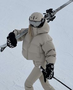 a woman is skiing down a snowy hill