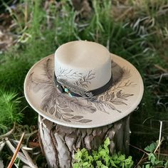 Grey Color Wide Brim Bolero Hat Shown. This Hat Style comes in Ivory/Beige, Grey & Pink and Black Burned designs using Pyrography techniques. Each Hat is burned freehand. He stencil, therefore each hat is a one of a kind. Each Hat is sealed with a weather proofer, good for 12 months. Hats made by PIPER Hat Co. also come with a signature travel bag and crafted macrame Wall Hanger. Hand Tooled Leather Hat, Artistic Short Brim Hat For Rodeo, Artistic Flat Brim Hat For Rodeo, Artistic Wide Brim Hat For Rodeo, Artisan Hat With Curved Brim And Feathers, Artisan Hat With Feathers And Curved Brim, Artisan Wide Brim Hat With Feathers, Bohemian Flat Brim Hand Painted Hat, Hand Painted Flat Brim Hat For Rodeo