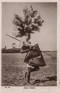 an old photo of a person holding a kite