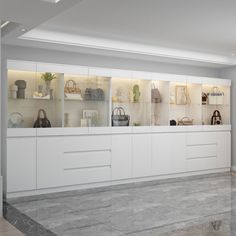 an empty room with white cabinets and bags on the shelves, in front of a large window