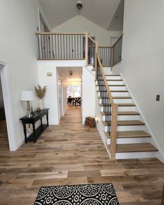 an open floor plan with stairs leading up to the second story