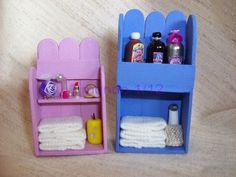 two toy shelves with towels, soaps and other items in them on a table