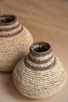 two woven baskets sitting next to each other