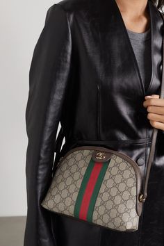 Gucci proves once again that its bags gain cult status as soon as they debut - it wasn't long after the Resort '18 runway before we saw this 'Ophidia' style on the arms of editors and influencers. Made from printed coated-canvas, it's trimmed with dark-brown textured-leather and the house's signature green and red webbing. We're struggling to think of outfits that it won't work with. Gucci Ophidia Bag Outfit, Gucci Handbags Crossbody, Gucci Bag Outfit, Gucci Bags Outlet, Gucci Bags Handbags, Gucci Ophidia Bag, Crossbody Bag Outfit, Gucci Crossbody Bag, Gucci Ophidia