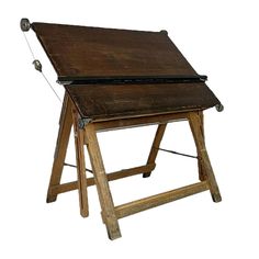 an old wooden desk sitting on top of a white background with no one around it