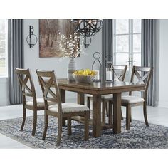 a dining room table with chairs and a rug