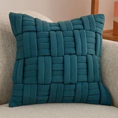 a blue pillow sitting on top of a couch