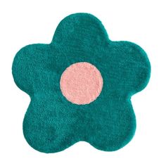 a green rug with a pink dot on it's center and a flower design in the middle