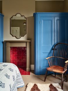 a bedroom with blue cabinets and a fireplace