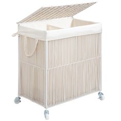 a white wicker laundry hamper with wheels on the bottom and side panels open