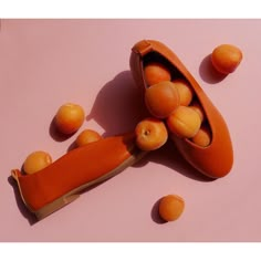 an orange object on a pink surface with peaches around it