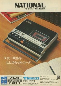 an old time radio sitting on top of a wooden table next to books and papers