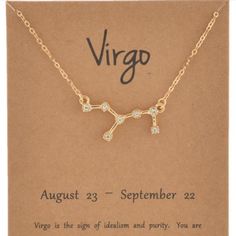 virgo zodiac sign necklace in gold with diamonds on the front and back, sitting on a card