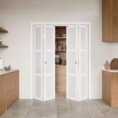 an empty kitchen with wooden cabinets and white doors