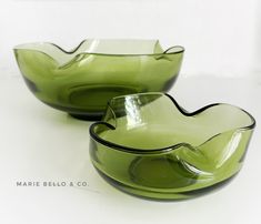 two green glass bowls sitting next to each other