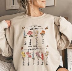 Introducing our delightful collection of sweatshirts designed for the special grandmothers in your life! From the charming "First Mom, Now Grandma" sweatshirt to the personalized birth month family member grandma sweater, these cozy pieces make perfect gifts. Celebrate the love and warmth of family with our stylish grandma crewnecks, ideal for every proud grandma 👵✨ Unveil the charm of cozy elegance with our delightful collection of sweatshirts, crafted especially for the grandmothers who sprinkle joy in our lives! From the heartwarming "First Mom, Now Grandma" to the bespoke birth month family member sweatshirt, each piece whispers love and warmth, making them the perfect tokens of appreciation for those remarkable matriarchs. 💖🌼 Imagine your grandmother, wrapped in the snug embrace of Stylish Grandma, Whisper Love, Grandma Sweatshirt, Grandma's Garden, Grandma Sweater, Iron Decor, Birth Month, Her Smile, Grandma Gifts