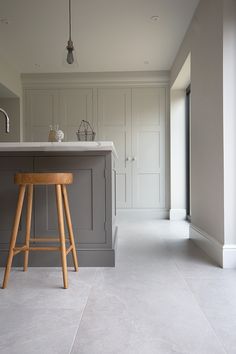 a kitchen with an island and stools in it