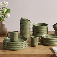 green dishes and cups on a wooden table