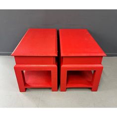 two red side tables sitting on top of each other