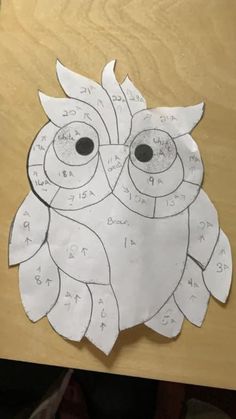 an owl made out of paper with numbers on it