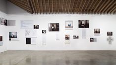 an art gallery with white walls and pictures on the wall