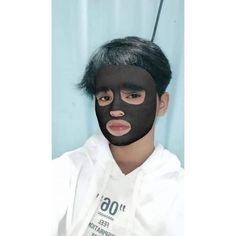 a person with a black mask on their face