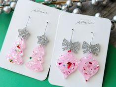 Pale Pink Confetti Earrings, 3 Designs These pink theme confetti earrings are perfect for the holiday season and are stylish and different with the confetti and pale pink colored acrylic.  Stand out at your family or work Christmas party with these unique Holiday earrings! Please choose either the Christmas tree, ornament, or light bulb design in the drop down menu.  Please see the photos for the drop length of each style. *Every earring is unique and the exact confetti look will vary from earring to earring as they are cut from one big sheet of acrylic.* Cute Party Jewelry With Glitter, Cute Glitter Jewelry For Party, Cute Glitter Earrings For Party, Whimsical Drop Earrings For Party, Silver Earrings For Holiday Parties, Sparkling Jewelry For Christmas Party, Christmas Party Jewelry With Sparkling Details, Cute Christmas Party Jewelry, Sparkling Christmas Party Jewelry