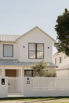 a white house with a fence around it